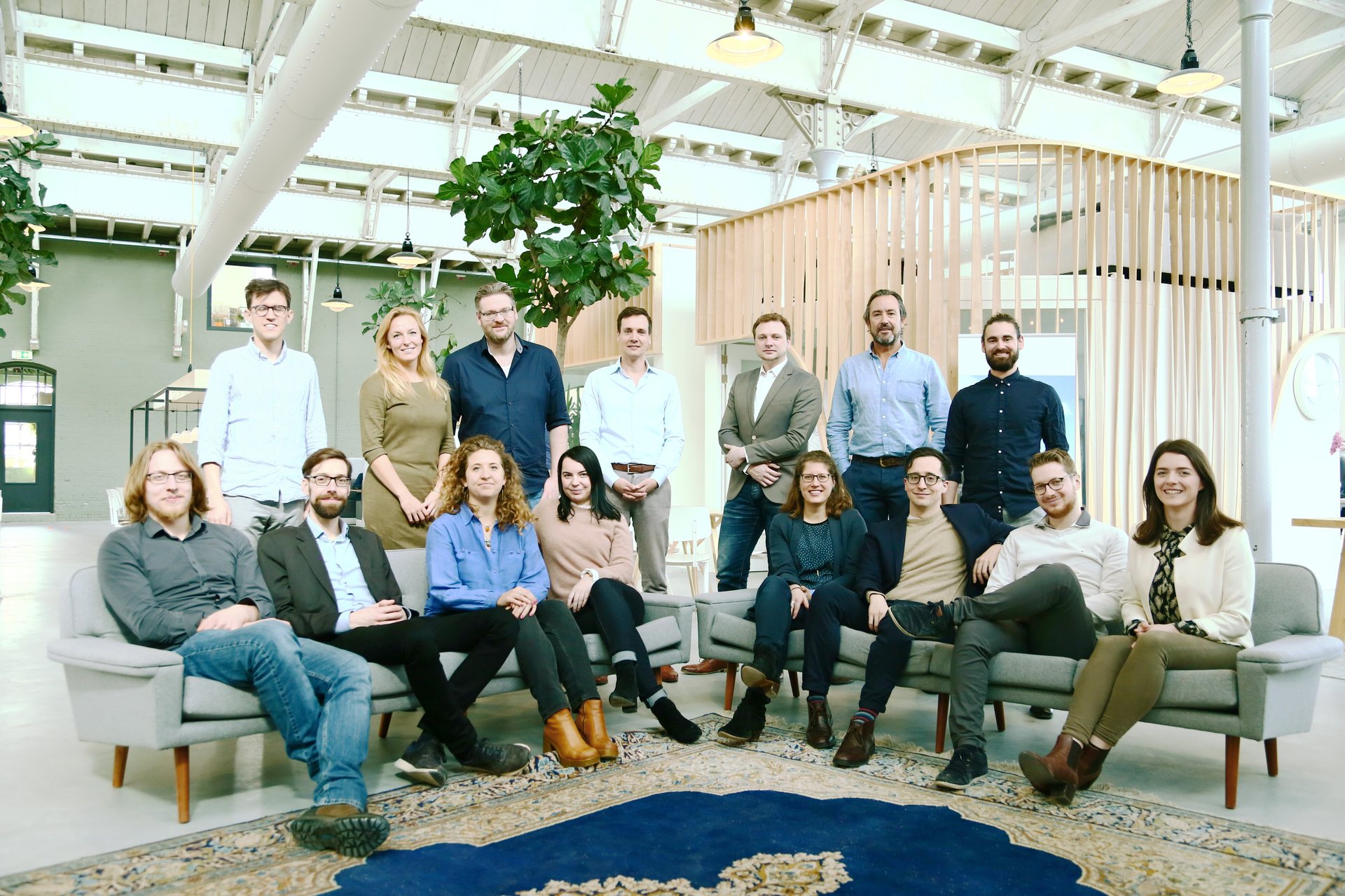 The Except team, about twenty people, sitting and standing together in the studio.